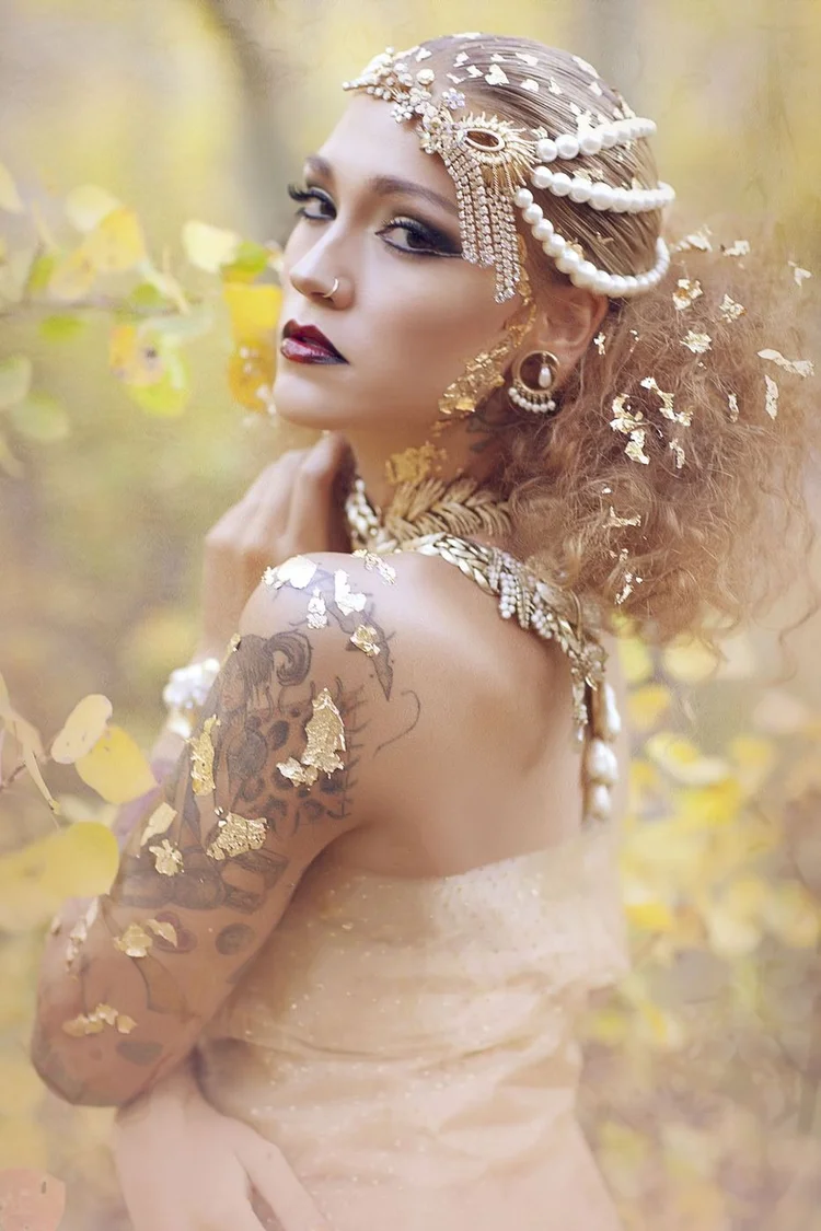 Close portrait in gold leaf, pearl strands across the hair, Andrea Li pieces