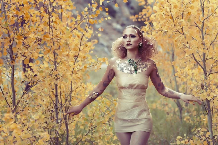Stefanie Dolenc walking through a golden aspen grove, landscape view