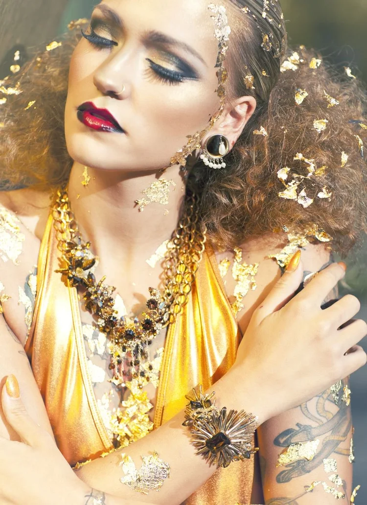 Close portrait in gold leaf, Andrea Li cuff and rings