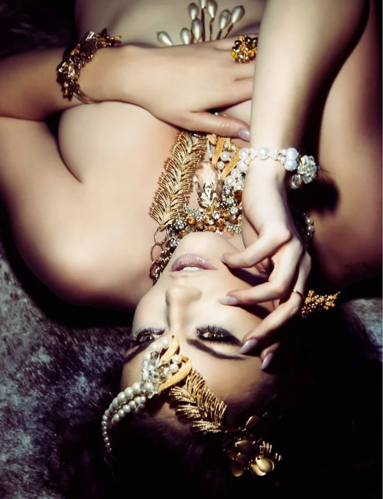 Apt 5802 page: the model reclining on fur, upside down, in Andrea Li gold leaf and pearl jewelry