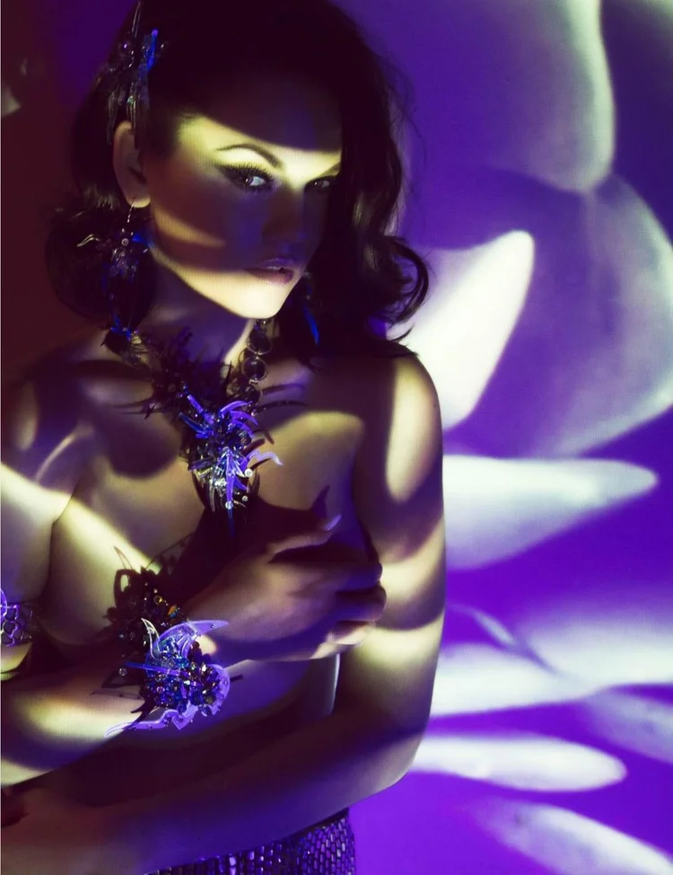Apt 5802 page: purple projected light over the model and an Andrea Li dark crystal necklace and ring