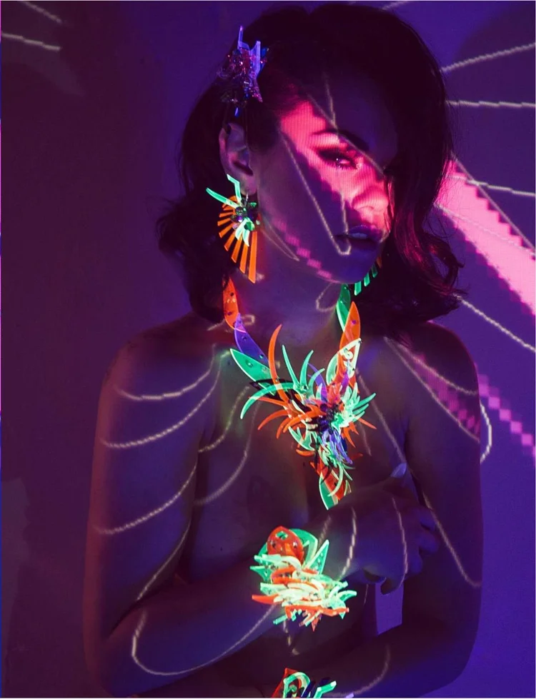 Apt 5802 page: violet light lines across the model and Andrea Li neon spiked earrings and necklace