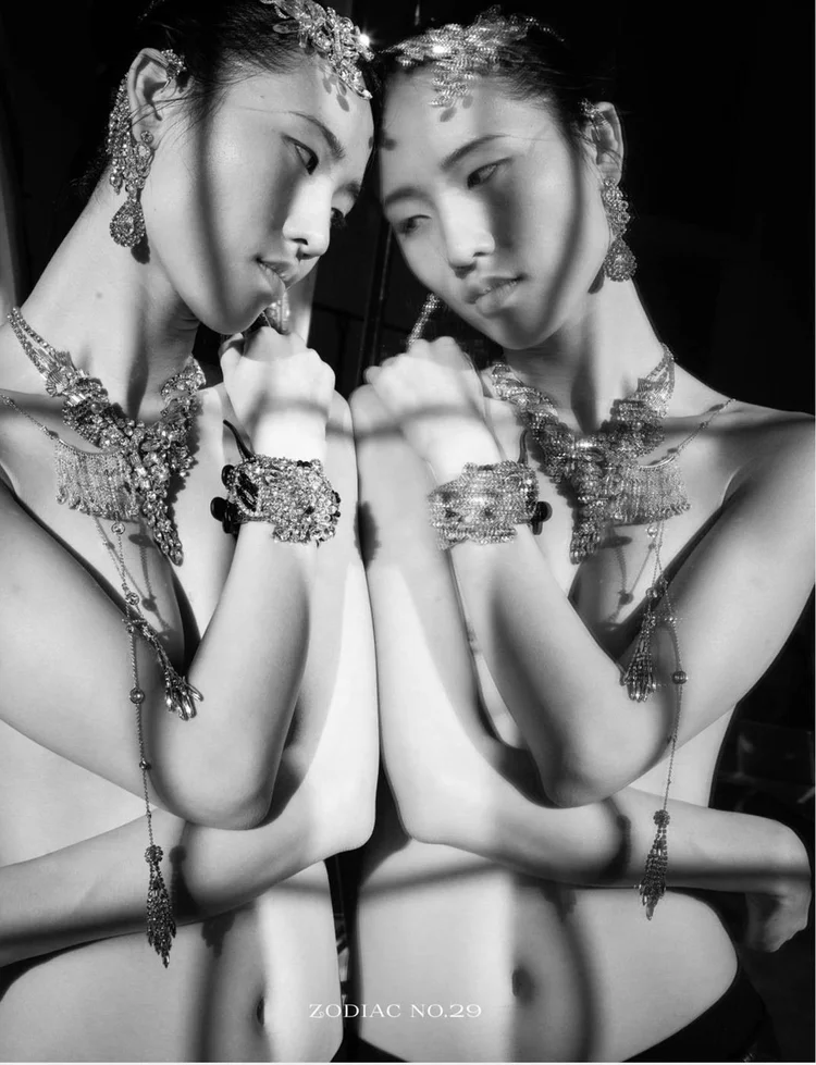 The Twins: the model and her reflection side by side, arms folded, in Andrea Li crystal necklaces and cuffs