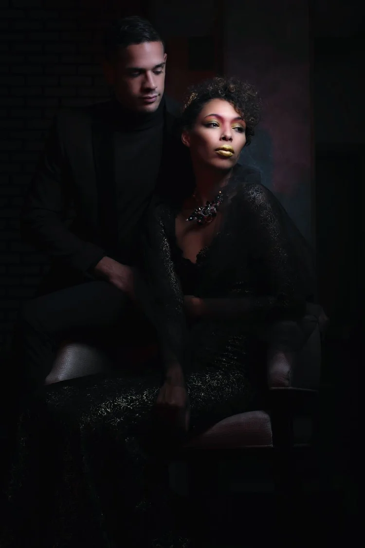 A couple in dark styling, the man in a crown