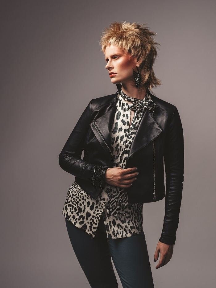 Space Oddity look: a model in a leather jacket and leopard blouse with Andrea Li earrings
