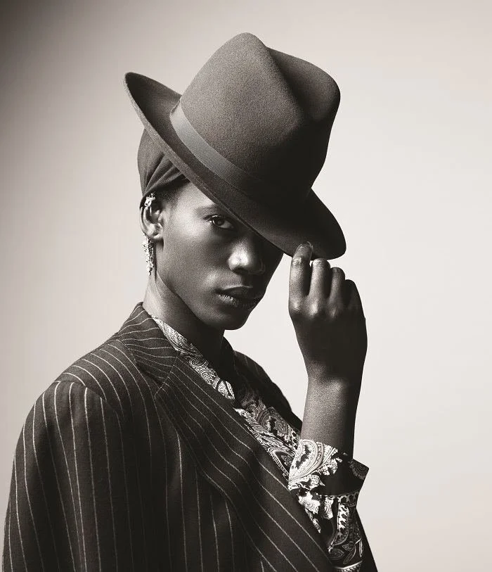 Delirious look: a model in a pinstriped jacket and fedora with an Andrea Li ear cuff