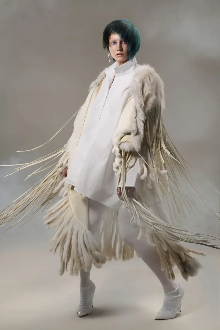 The teal-bob model in a white fringed fur coat