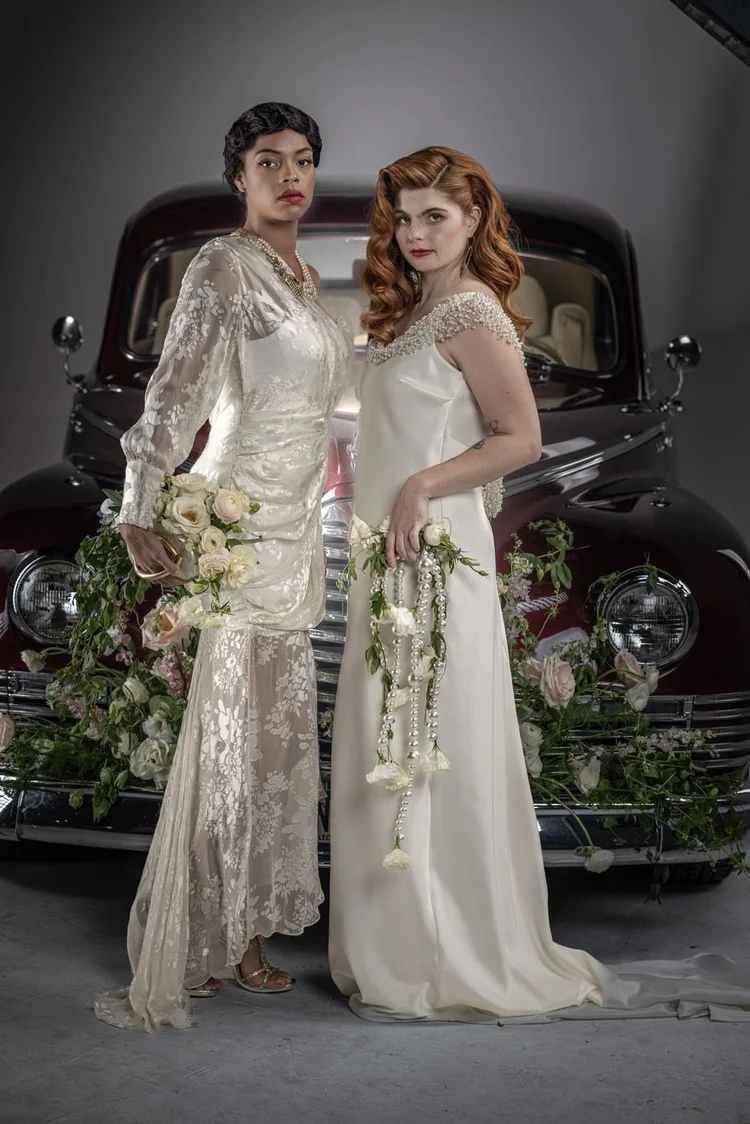Two brides side by side in ivory gowns