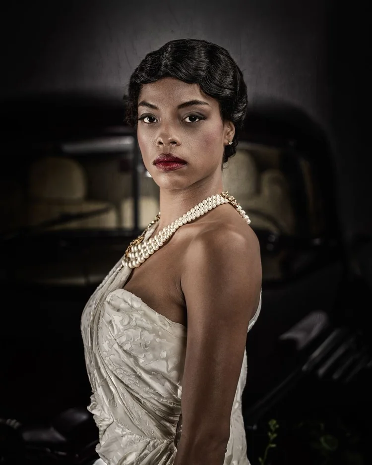 Close portrait of a model in an ivory gown with long pearl strands
