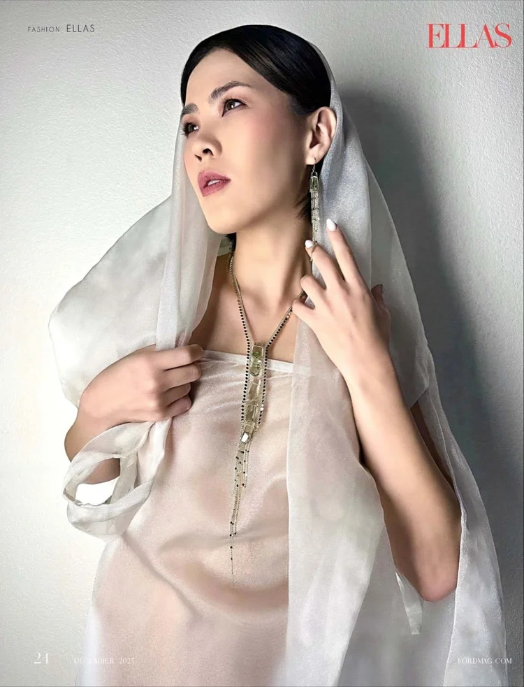 ELLAS page 21, December 2025: the model in a white organza veil wearing an Andrea Li long quartz lariat and earrings