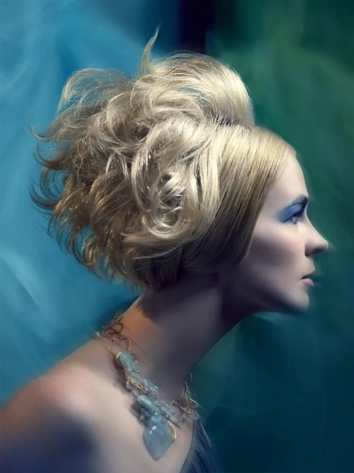 A blonde updo in profile with an Andrea Li wire-woven necklace set with a large pale blue stone