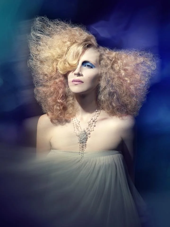 Big crimped blonde hair, a strapless gown and an Andrea Li beaded cascade necklace