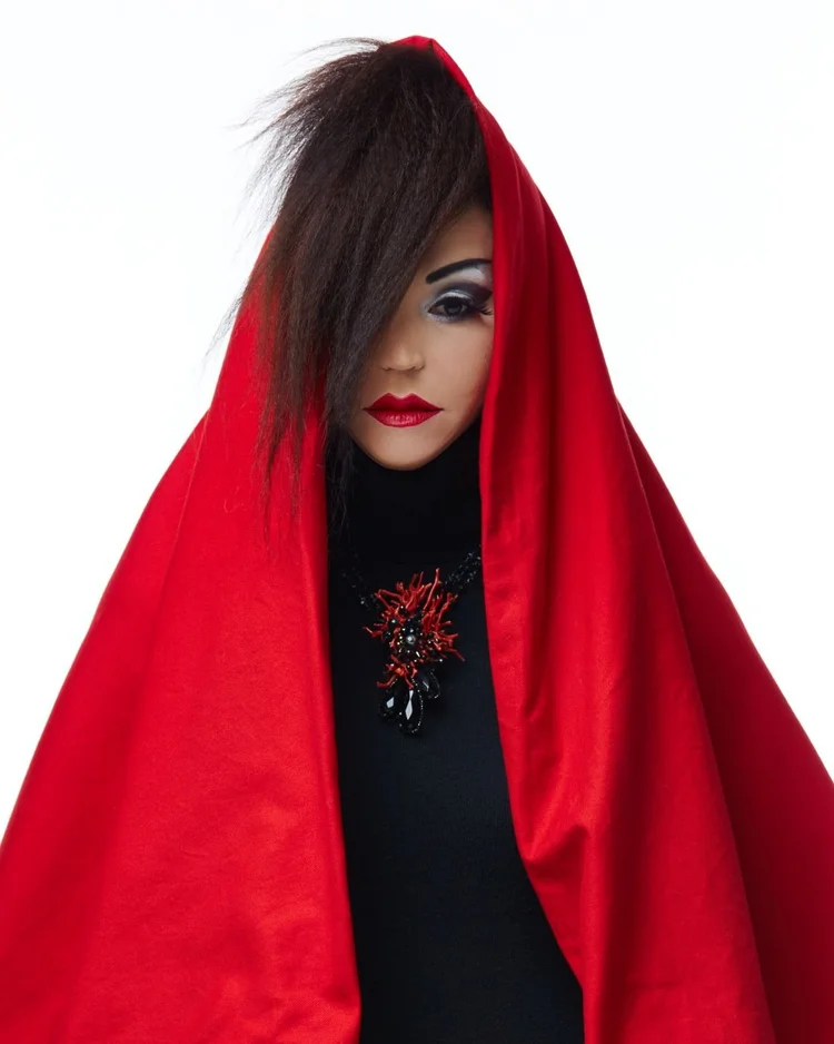 A model in a red hood wearing an Andrea Li red and black cluster pendant