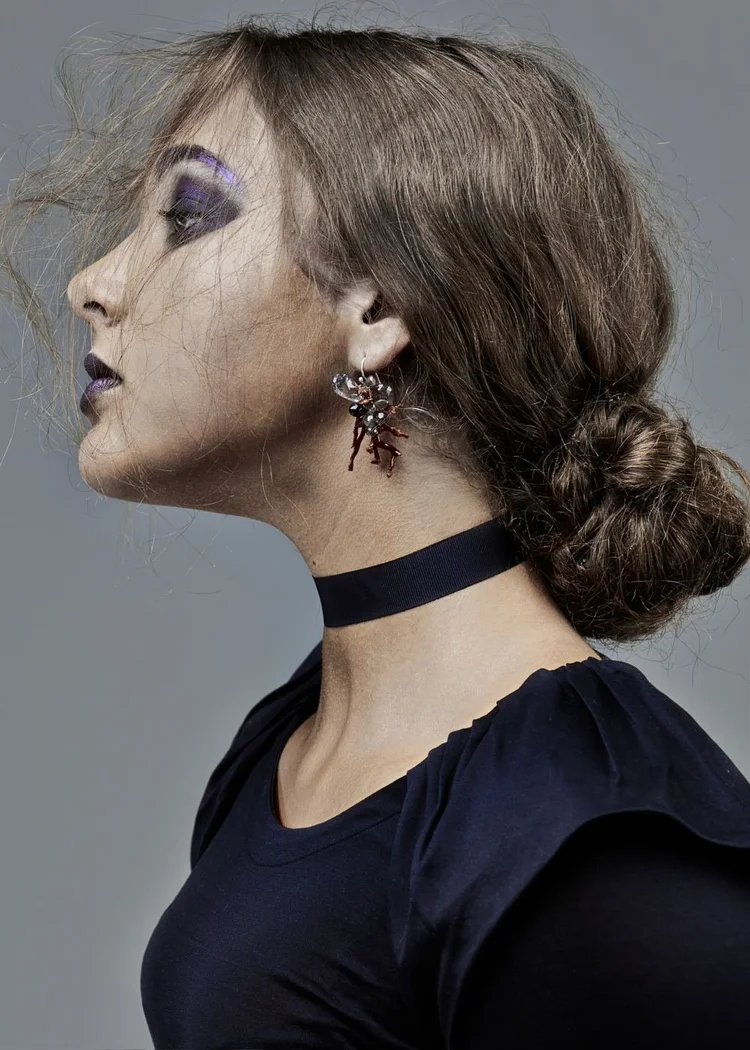 Profile with veil makeup and an Andrea Li red and black spiky earring