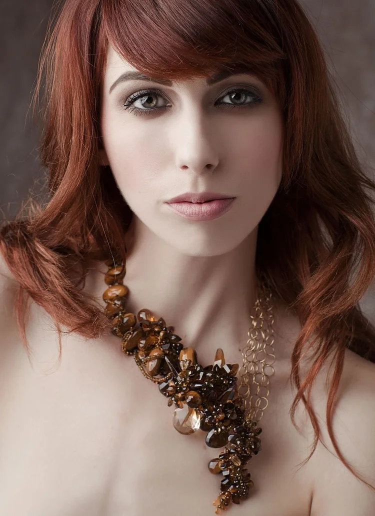 A red-haired model wearing an Andrea Li smoky cluster necklace