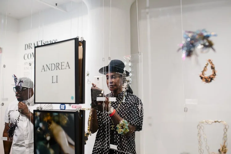 Guests in front of the ANDREA LI placard and her hanging cluster pieces