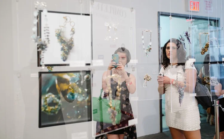 Guests photographing the Andrea Li display with its framed prints