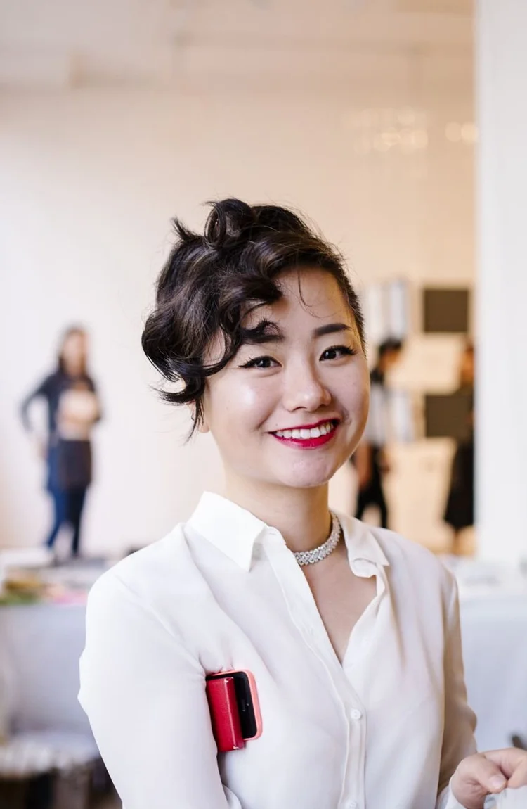 A smiling guest in a white shirt at preview night