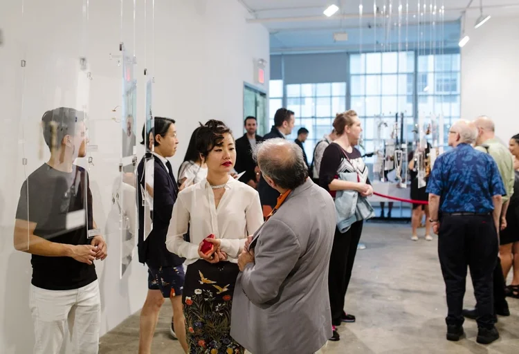 Guests in conversation across the gallery