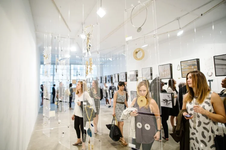 The gallery full of guests among the hanging displays