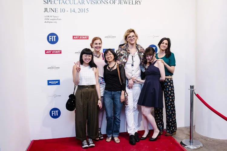 A group photo on the red carpet at the DRAFTspace step-and-repeat