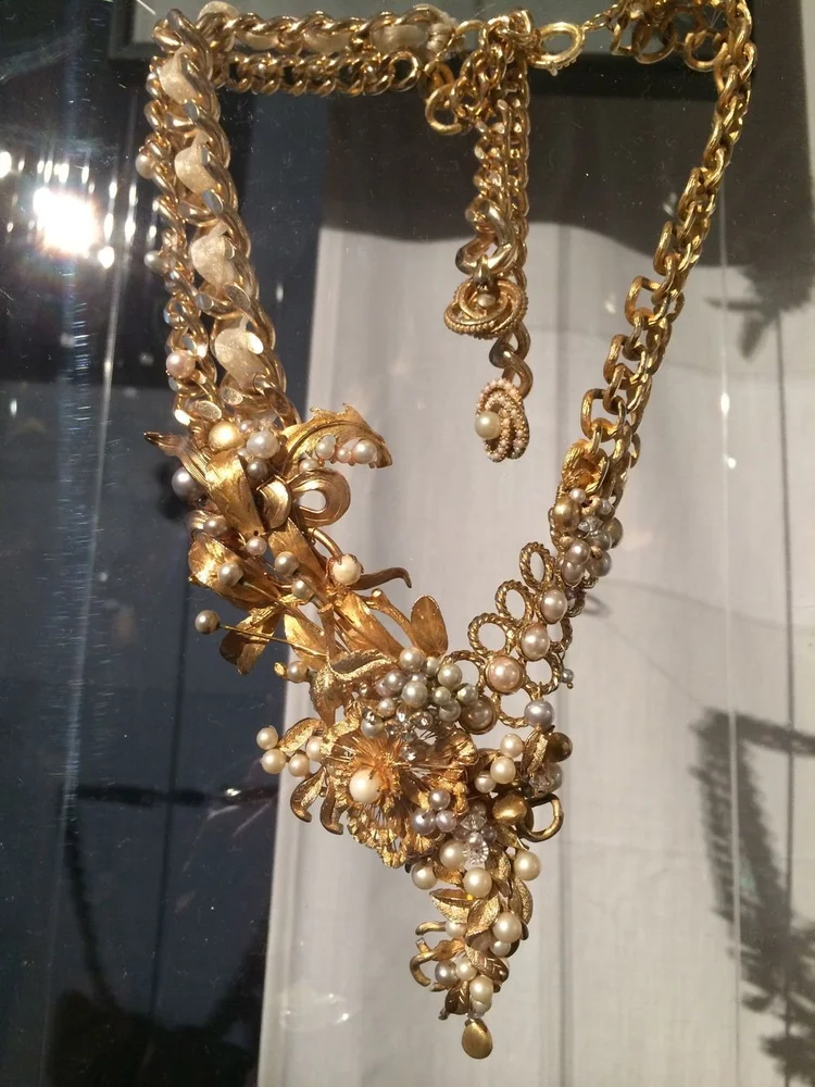 An Andrea Li gold leaf, pearl and chain necklace in the display