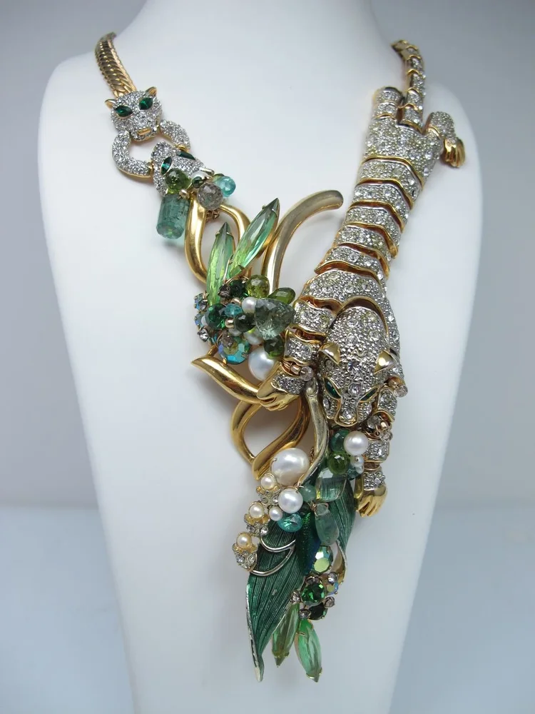 Studio photo on a bust: a gold necklace with a rhinestone panther