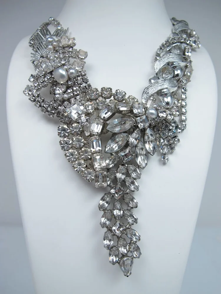 Studio photo on a bust: a silver rhinestone cascade collar