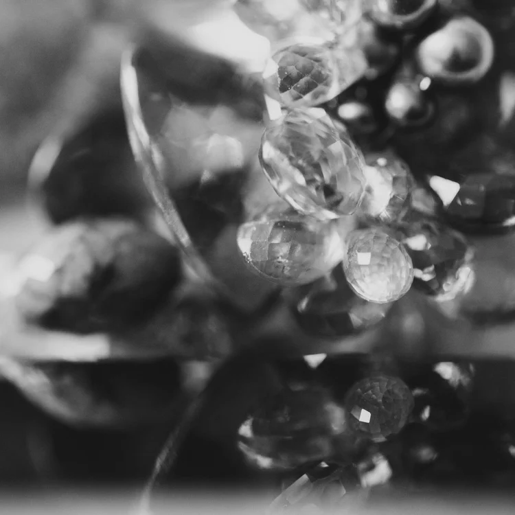 Black and white macro of faceted briolette gemstone clusters
