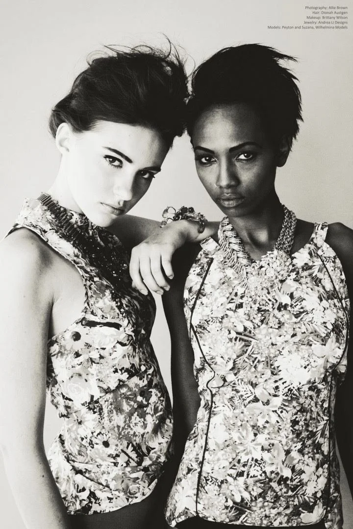 Black and white: two models leaning together in floral tops, Andrea Li necklaces
