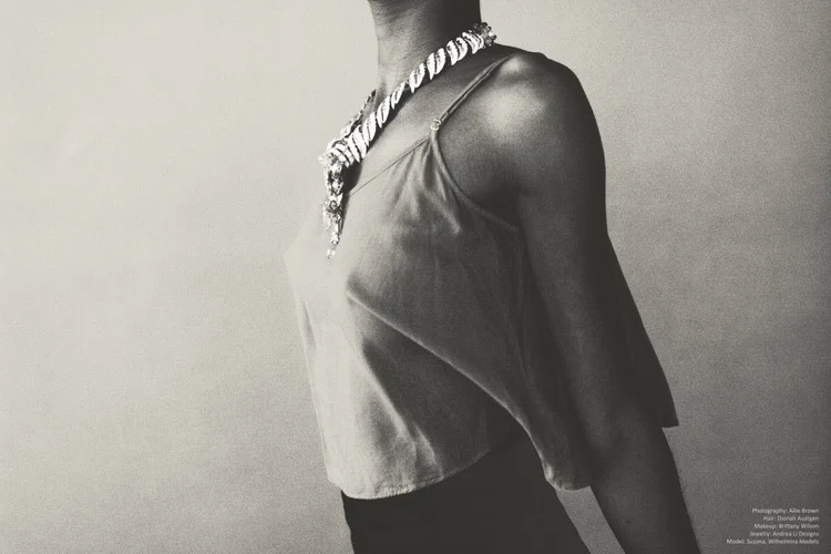 Black and white: a model in a tank top with an Andrea Li statement necklace, cropped at the face