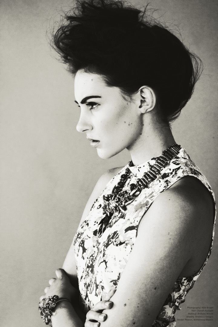 Black and white profile in a floral top, arms crossed, Andrea Li necklace
