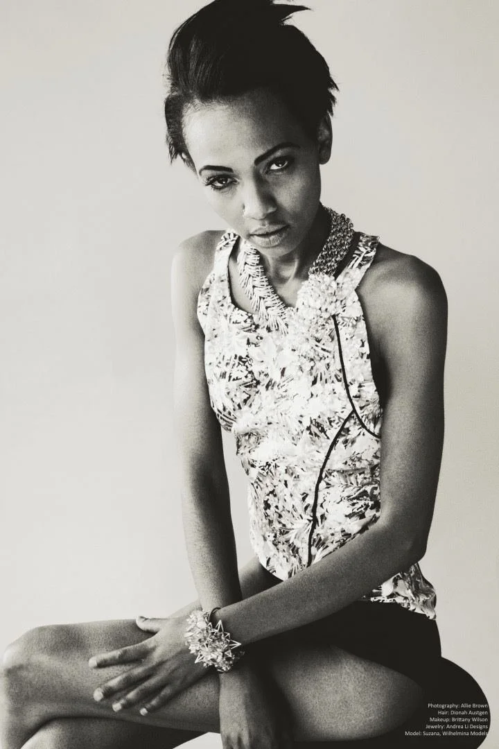 Black and white: a model seated in a floral top with an Andrea Li cluster cuff