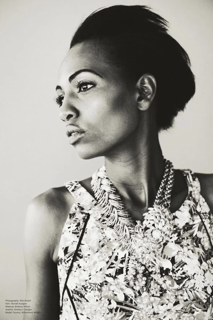 Black and white profile: a model in a floral top with an Andrea Li chain necklace