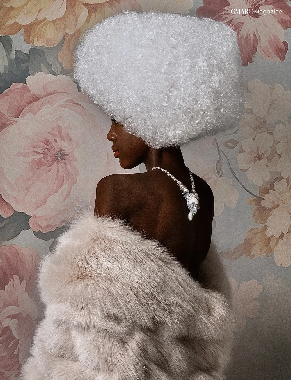 GMARO Magazine page: a model seen from behind against a floral wall, a moonstone necklace by Andrea Li falling down her back