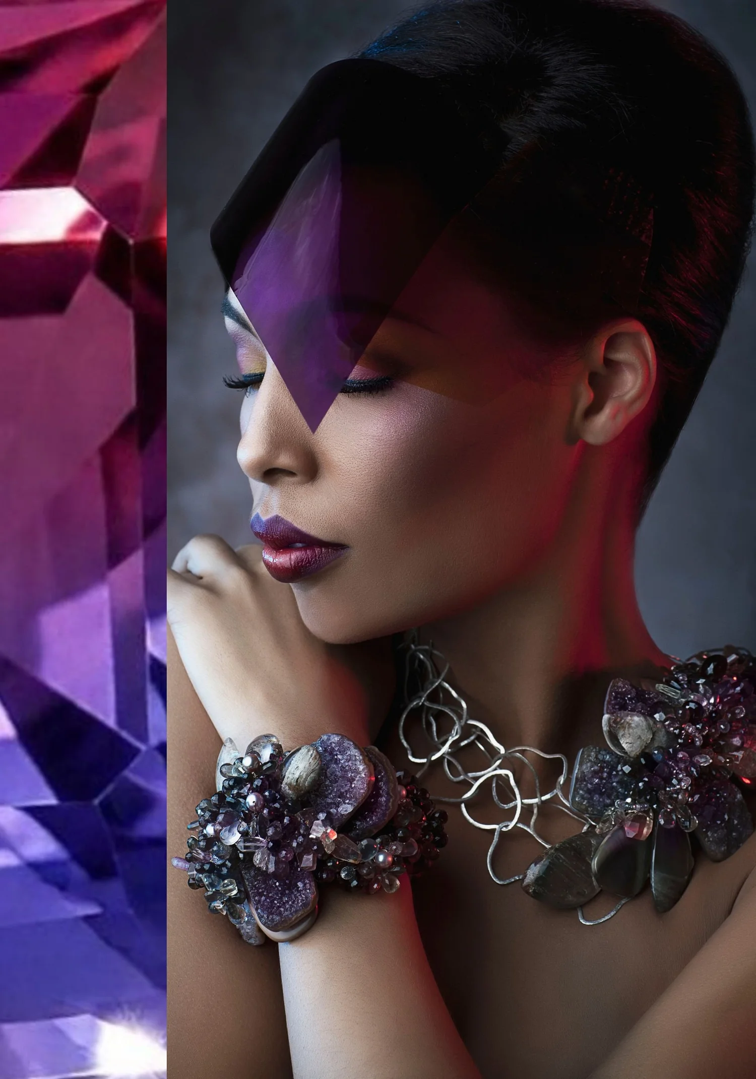 A model with sleek dark hair and violet makeup wearing a purple amethyst cluster cuff and a silver wire collar set with amethyst druzy and smoky stones, beside a close-up of faceted violet crystal