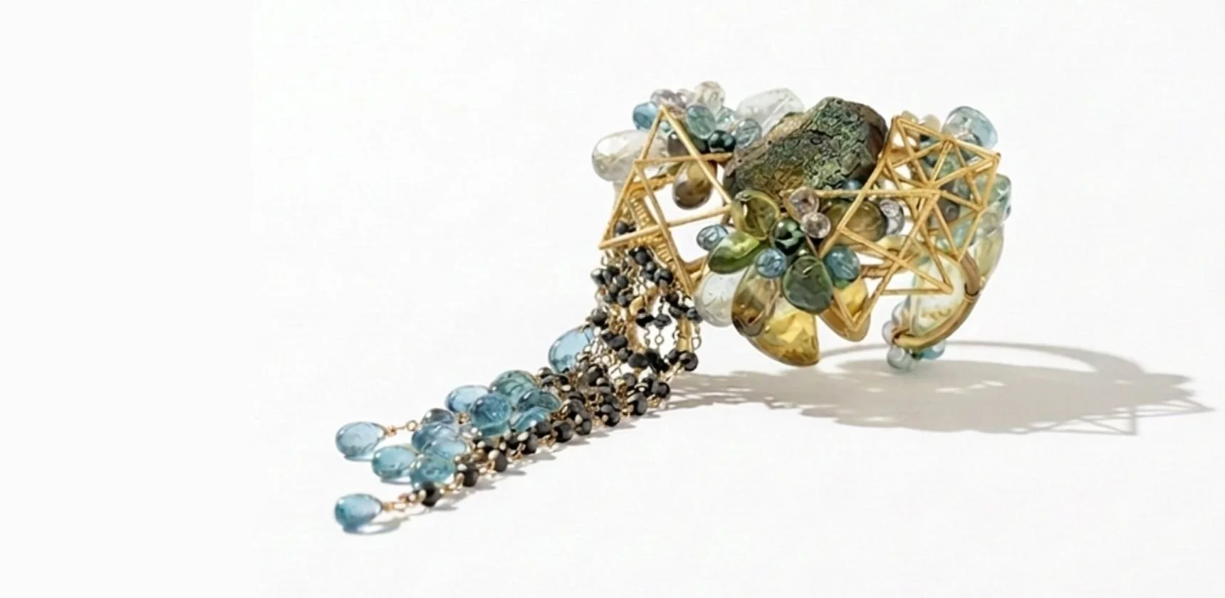 A green, blue and brown gemstone and 3d printed cuff