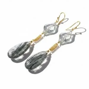 Long teardrop earrings with dark included quartz drops below clear crystal and gold, by Andrea Li
