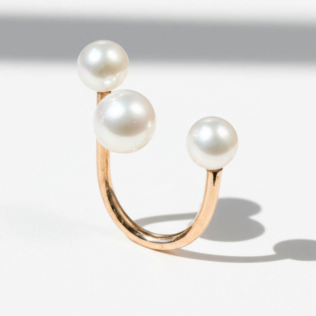 three pearl and gold ring.png