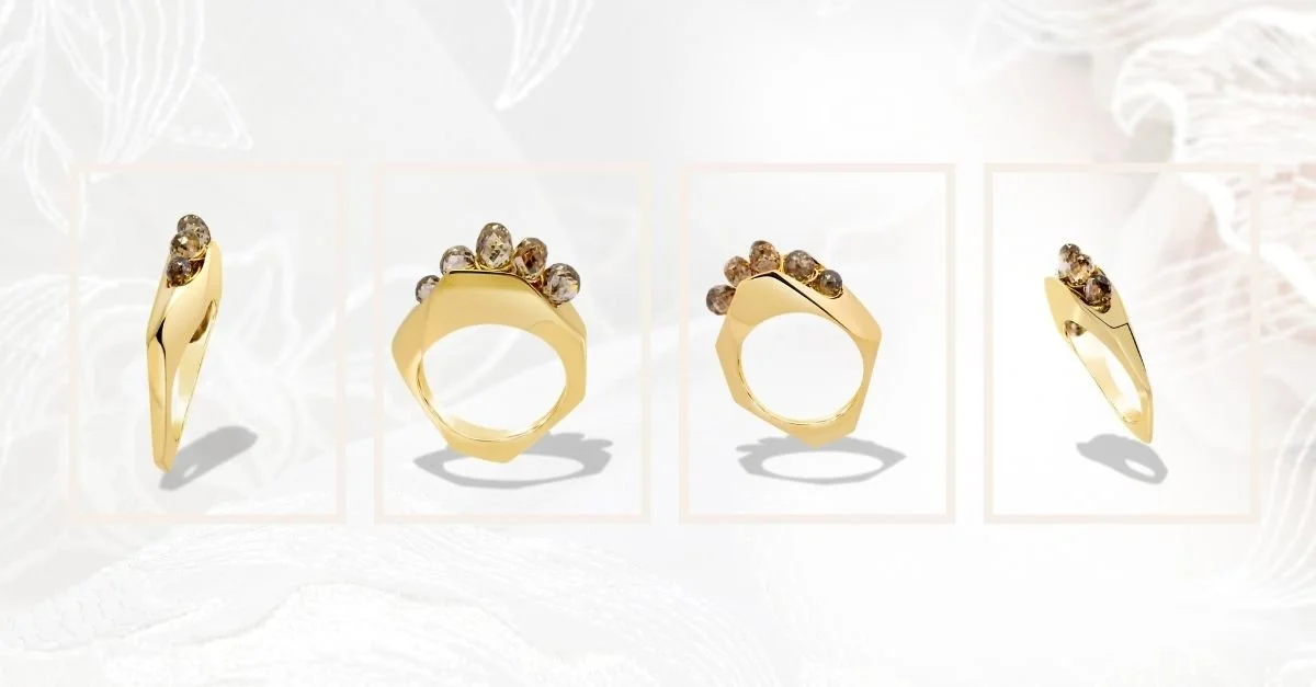 Four product views of a modern gold statement ring featuring a sculptural band and a cluster of champagne-toned gemstones, shown from multiple angles against a soft neutral background.
