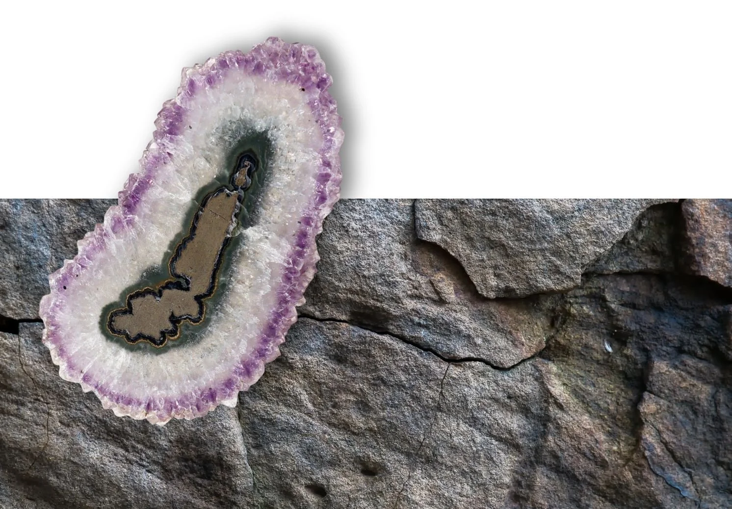 A one-of-a-kind amethyst stalactite slice set point-down against volcanic rock, the way it first formed inside the geode