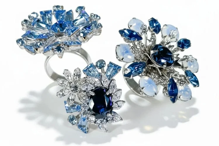 Three custom Andrea Li blue gemstone cocktail rings arranged together