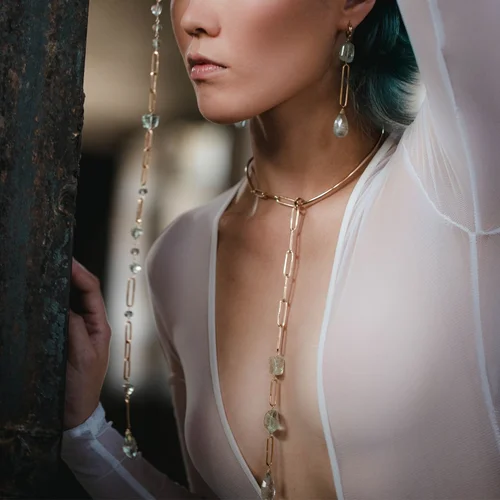 A model wearing a long Andrea Li pendant that draws the eye down