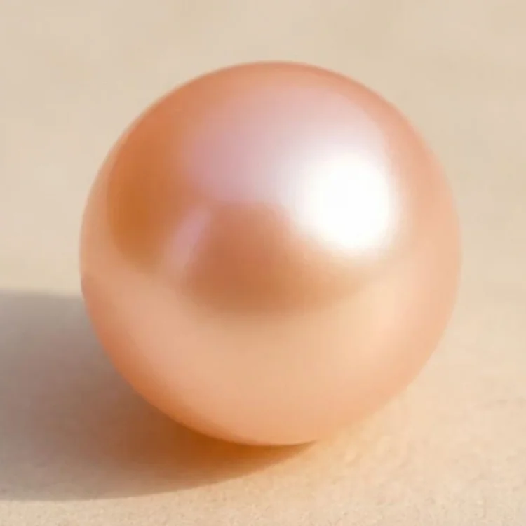 Illustration of a round peach pearl, soft apricot with a pink overtone