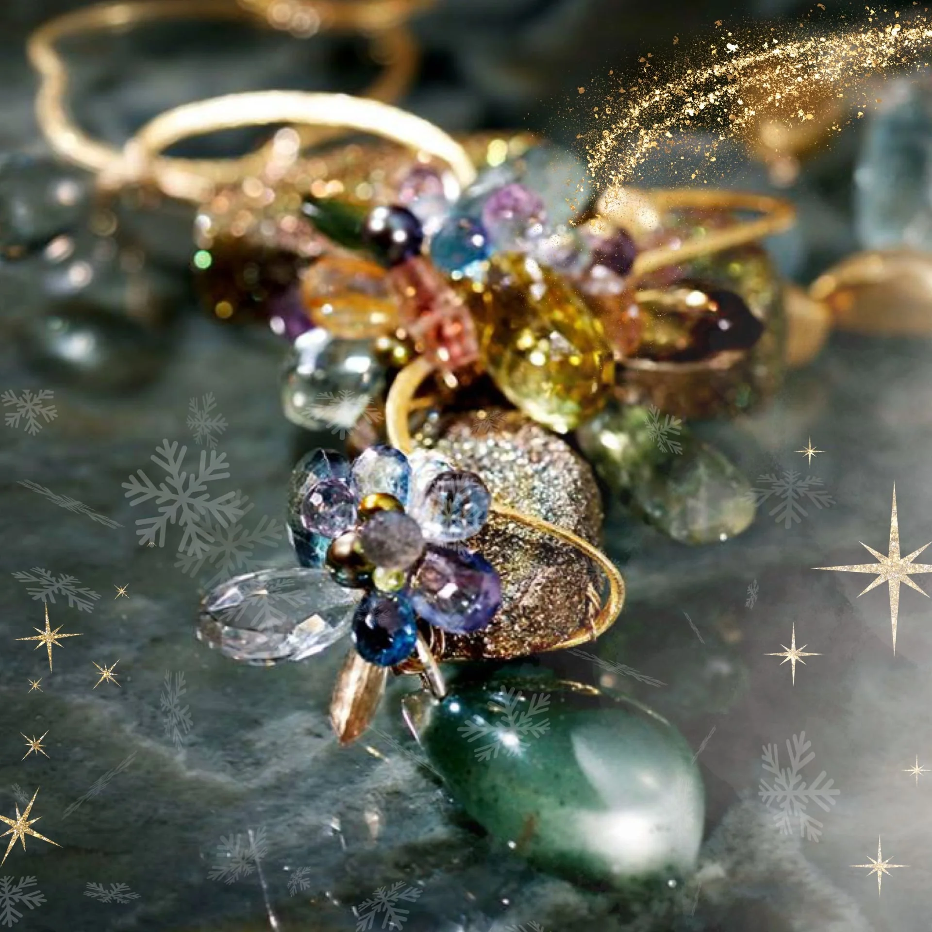 Close-up of a colorful gemstone cluster ring with gold accents, holiday sparkles, and snowflake overlays on a dark green surface.
