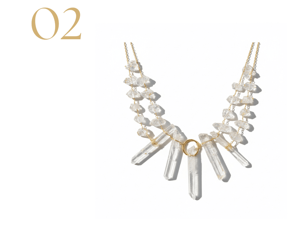 Product photo of a Herkimer diamond statement necklace featuring layered gold chains with raw Herkimer diamond stones and five clear crystal point drops on a white background.
