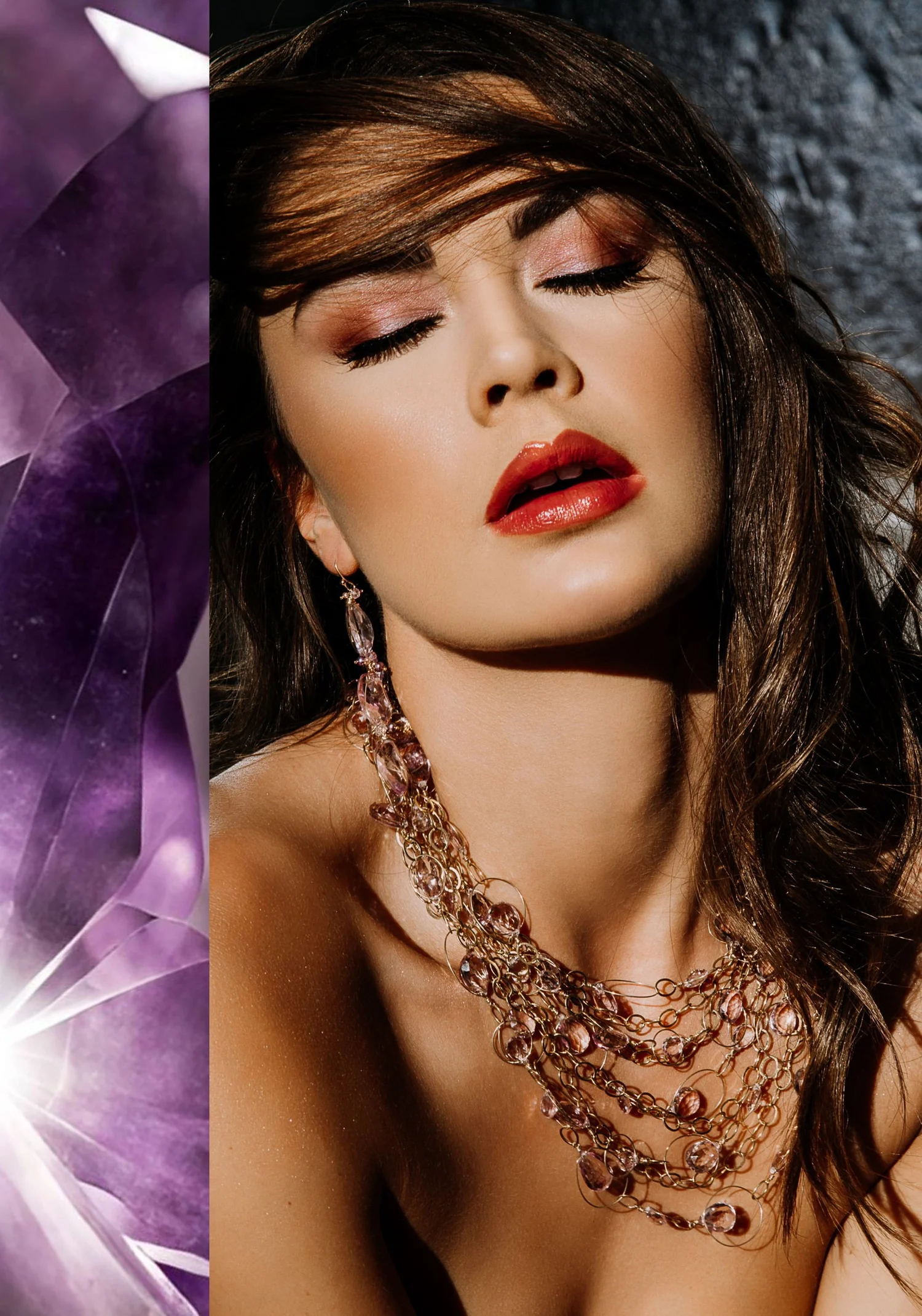 A model with tousled brown hair wearing a long drop earring and a layered gold chain necklace strung with lilac amethyst beads