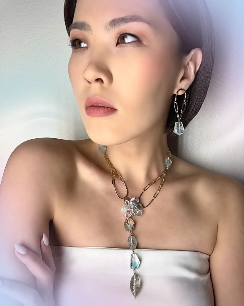 model wearing a pastel gemstone necklace and topaz earrings