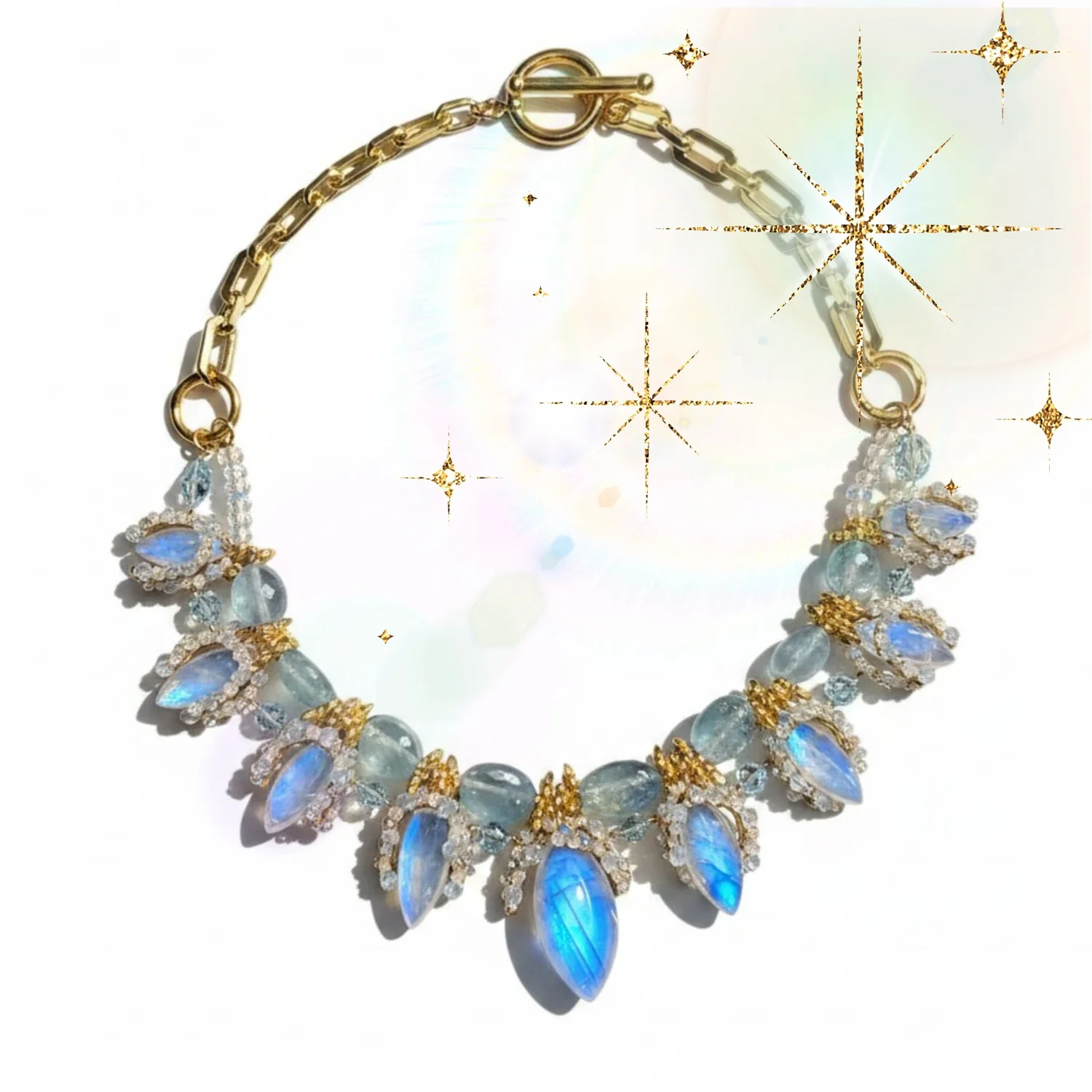 Moontide Necklace by Andrea Li, a graduated fan of marquise moonstone drops on a gold chain, with soft gold sparkles