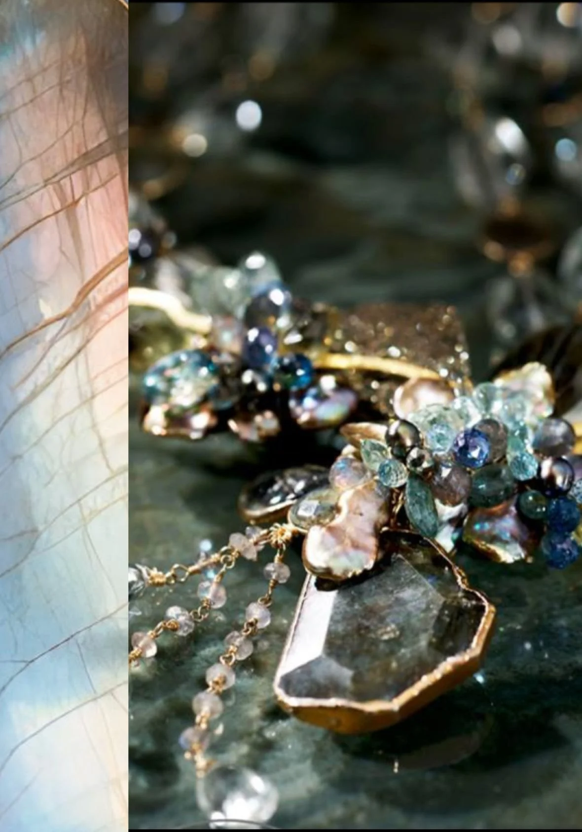 Close-up of pastel gemstone jewelry on a dark stone surface, featuring clustered beads, gold accents, and a faceted crystal pendant.